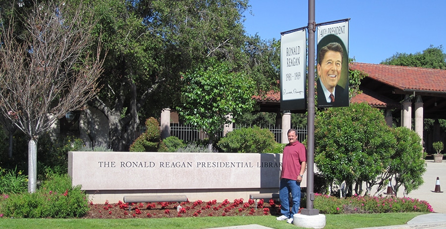 The Author standing next to the Ronald Reagan Library Sign